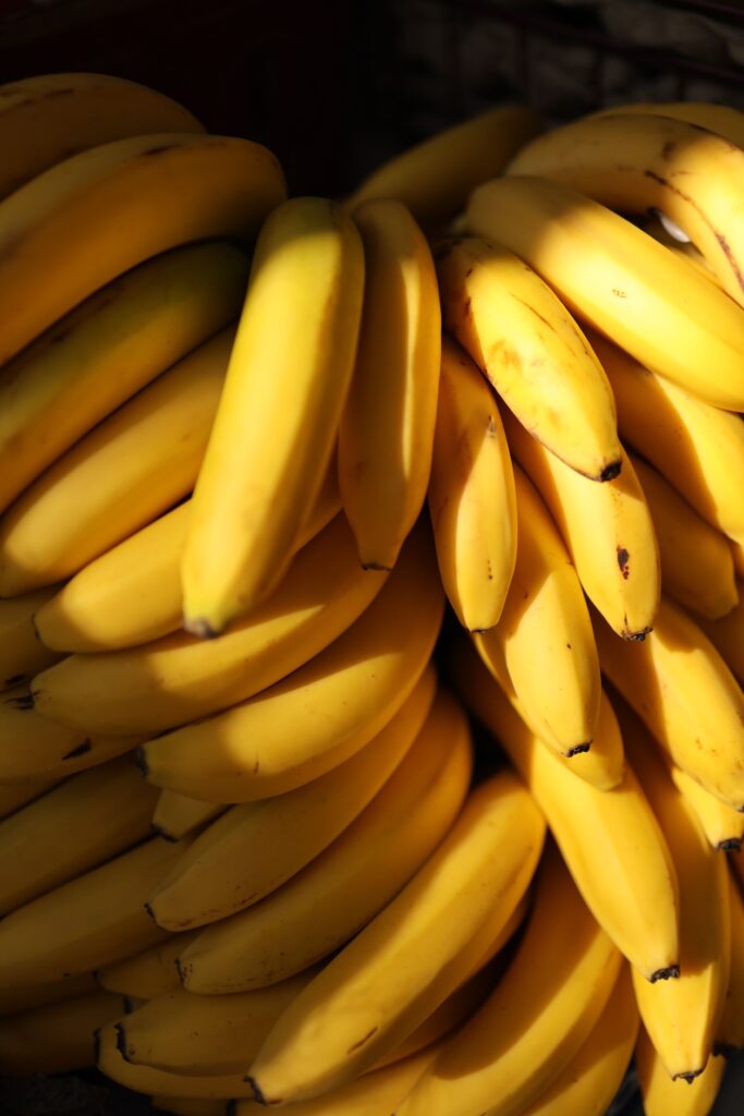 Dramatic close-up of a ripe banana bunch in warm light