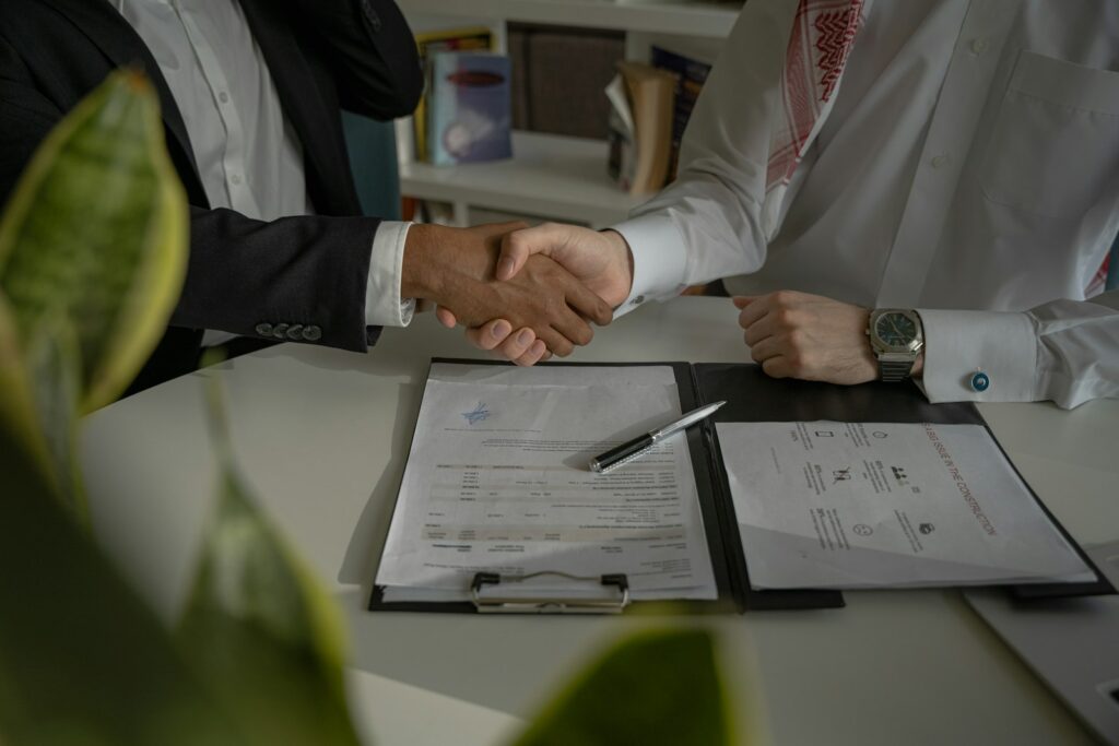 International trade partners shaking hands over a signed agreement