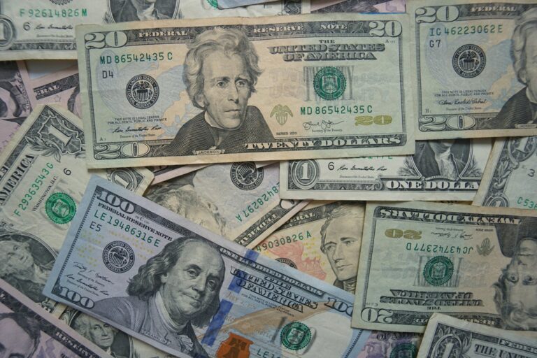 Close-up of stacked US dollar bills of various denominations